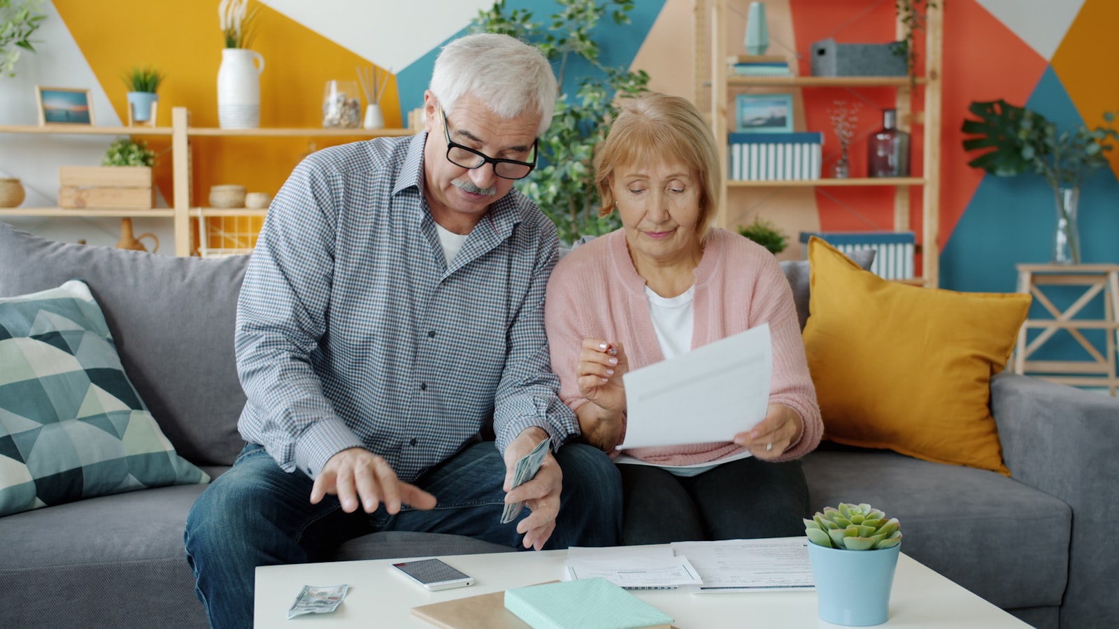 Older couple reviewing documents at home, used to illustrate family-based green card planning for spouses and parents